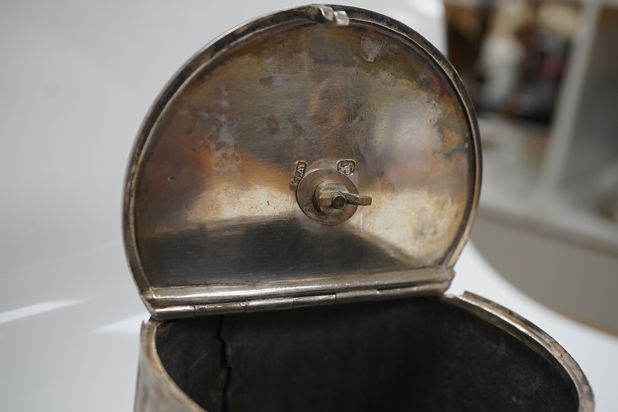 A George III fluted silver lead lined circular tea caddy, by Walter Tweedie, London, 1772, height 10cm excluding handle. Condition - poor